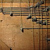 Fori di tarlo sulla tavola della catenacciatura della tastiera, prima del restauro